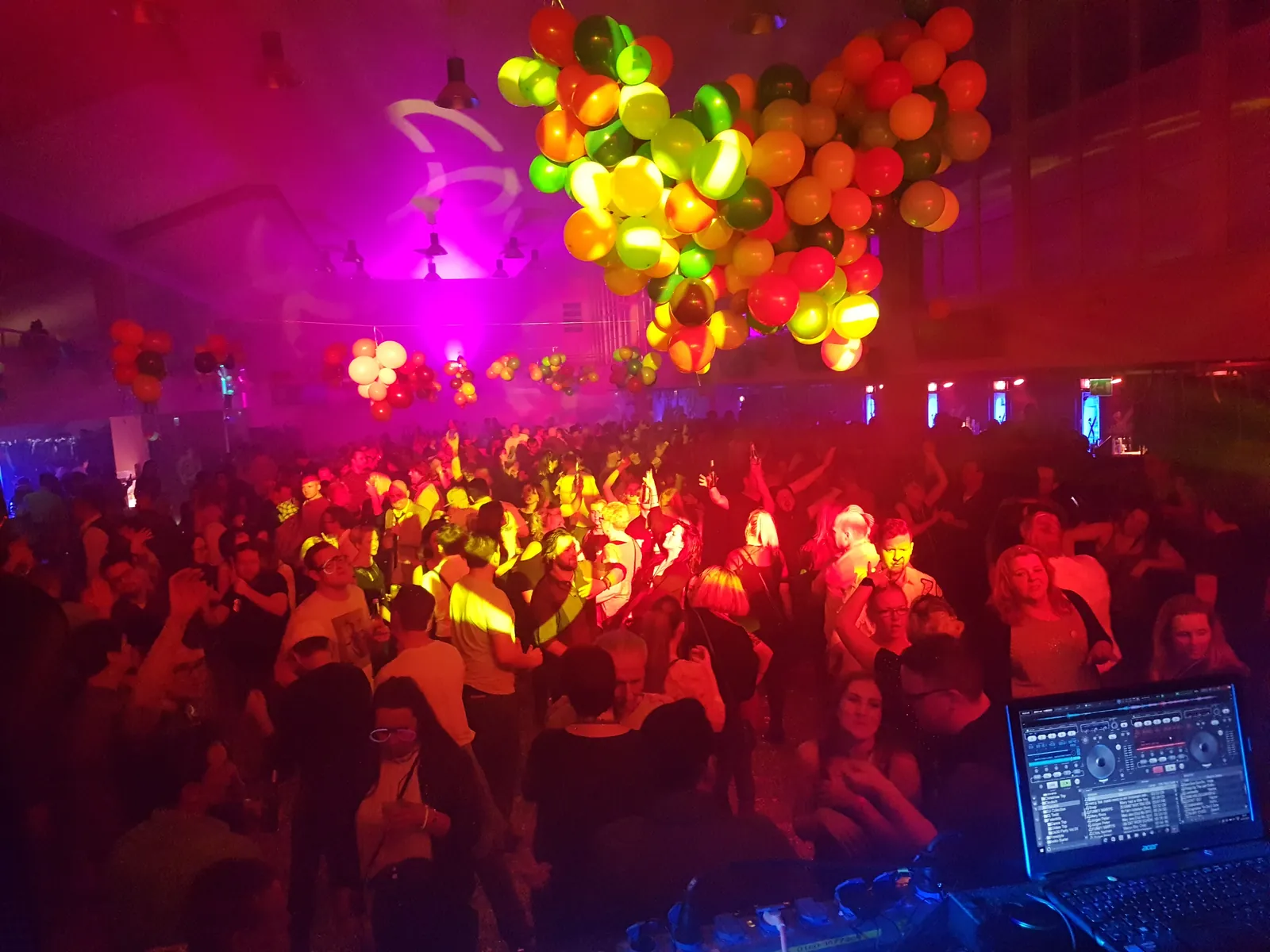 Tanzende Menge mit Luftballons auf der 90er Silvesterparty